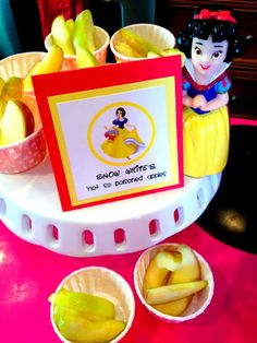 there is a table with some food on it and a sign that says snow white's 101th birthday cake