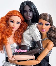 two dolls are hugging each other in front of a white background with the words barbie on it