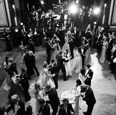 a group of people standing around each other on top of a dance floor