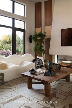 a living room filled with furniture and large windows