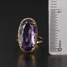 Style: Victorian Materials: 9K Gold Ring Size: 6.75 Hallmarks: 9 with Pictorial Markings Total Weight: 2.10 dwt Primary Stone Type: Amethyst Primary Stone Shape: Oval Faceted Primary Stone Count: 1 Primary Stone Dimensions: 20.00 mm x 10.00 mm Formal Gold Amethyst Ring With Diamond Cut, Classic Yellow Gold Amethyst Ring With Diamond Cut, Classic 14k Gold Amethyst Ring For Formal Occasions, Classic Hallmarked Amethyst Ring For Formal Occasions, Gold Amethyst Ring With Diamond Cut, Oval Shape, Gold Oval Amethyst Ring With Diamond Cut, Classic Formal Hallmarked Amethyst Ring, Oval Diamond Cut Yellow Gold Amethyst Ring, Oval Amethyst Ring In Yellow Gold With Diamond Cut