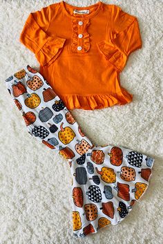 Top features solid orange body color w/ruffles & long sleeve cut. Bottoms feature multi shapes pumpkin prints on white background & flare legs. Soft, breathable, stretchy, and comfortable fabric. Perfect set for a western look. Material: Polyester & Spandex. Includes: Top & Bottoms. Fitted Ruffle Sets For Fall, Cute White Sets For Fall, Fitted Matching Sets For Fall, Orange Long Sleeve Halloween Sets, Cute Printed Fitted Sets, Long Sleeve Ruffled Sets For Fall, Fitted Orange Tops For Halloween, Playful Fitted Tops For Fall, Fitted Cotton Set For Fall