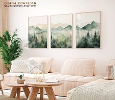 a living room filled with white furniture and paintings on the wall above it's coffee table