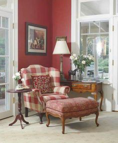 a living room with red walls and furniture