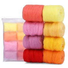 six skeins of dyed wool in different colors and sizes on a white background