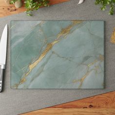 a marble cutting board and knife on a table