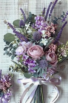 two bouquets with purple flowers and greenery