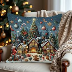 a christmas pillow sitting on top of a couch next to a christmas tree and presents