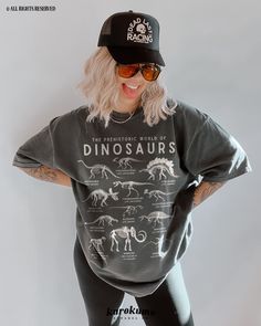 "This Unisex garment-dyed t-shirt features \"The Prehistoric World of Dinosaurs\" with a set of vintage dinosaur species illustrations. It is the perfect gift for dinosaur lovers, science teachers and present / future paleontologists! Make sure to check out the other garment options below :) » O P T I O N S « ‣ Crewneck: https://www.etsy.com/listing/1119390683 » A B O U T « ‣ This item is made to order using direct-to-garment (DTG) printing technology. This digital process involves the printer i Cute Dino Outfit, Cotton Dinosaur Print Tops For Streetwear, Unisex Dinosaur Print Crew Neck Top, Casual Dinosaur Print Tops For Streetwear, Relaxed Fit Dinosaur Print Crew Neck Tops, Black Dinosaur Print Crew Neck Top, Dinosaur Print Graphic Tee With Short Sleeves, Black Dinosaur Print Short Sleeve T-shirt, Black Short Sleeve T-shirt With Dinosaur Print