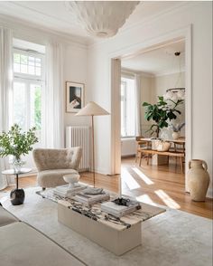 a living room filled with furniture and lots of windows