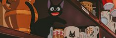 a black cat standing on top of a set of stairs in front of cartoon characters