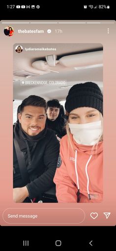 two people wearing face masks in the back of a car, one is looking at the camera