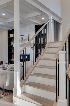 a living room filled with furniture and a stair case