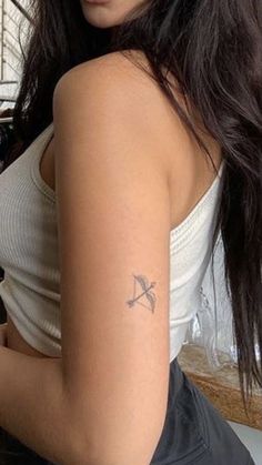 a woman with a small tattoo on her arm