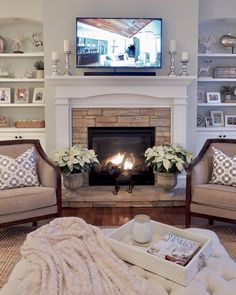 a living room filled with furniture and a flat screen tv mounted above a fire place