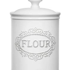 a white canister with the word flour written in silver on it and an ornate design