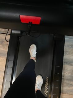 a person standing on top of a treadmill with their feet up in the air