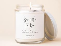 a white candle with the words bride to be printed on it