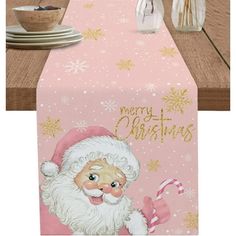 a pink table runner with santa clause on it