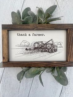 a wooden frame with a drawing of a tractor and the words thank a farmer