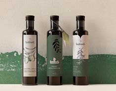 three bottles of olive oil on a shelf