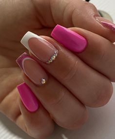 a woman's hand with pink and white acrylic nails