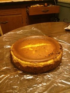 a cake sitting on top of a table covered in plastic