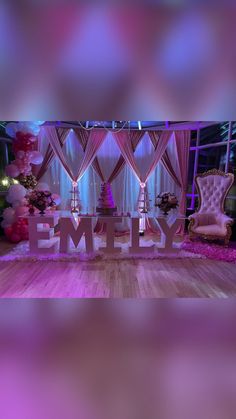 an empty stage with the word family spelled out in front of it and pink drapes