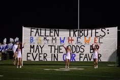 some cheerleaders are standing in front of a banner