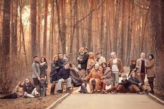 a group of people are posing for a photo in the woods