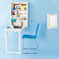 an open refrigerator sitting on top of a blue wall next to a chair and window