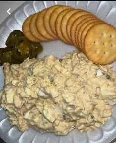 a white plate topped with crackers and dip