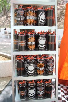 a shelf filled with lots of black and orange beer bottles on top of a checkered floor