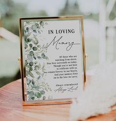 a card that says in loving memory sitting on top of a wooden table