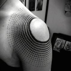 a black and white photo of a man's upper half sleeve with dots on it