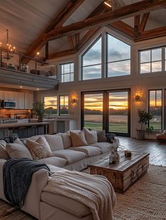 a large living room filled with furniture and lots of windows on top of the walls