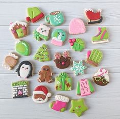 many different decorated cookies on a white table