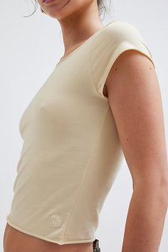 Out From Under tee with a boatneck. Designed in Out From Under Cotton Compression for medium compression. Super-soft knit tee in a stretchy bodycon fit that's cropped above the waist. Can be worn on or off-the-shoulder for a personalized look. Find it only at Urban Outfitters. Features Out From Under Cotton Compression boatneck tee Fitted tee Soft & stretchy medium compression knit Rolled edge finishing throughout Wide boatneck with cap sleeves Slim & stretchy compression fit Cropped length Easy Fitted Seamless T-shirt For Spring, Seamless Second-skin Crew Neck Top, Seamless Fitted T-shirt, Seamless Second-skin Short Sleeve Tops, Casual Second-skin Short Sleeve Top, Bodycon Short Sleeve Elastane Top, Basic Crew Neck Elastane Top, Basic Stretch Top With Scoop Back, Seamless Snug Fit Scoop Neck Top