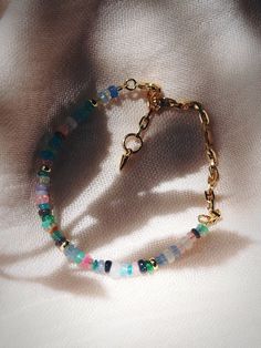 This modern rainbow opal and chain bracelet is a must have. The elegant mix of Opals, Gemstones, and Gold make this beaded bracelet versatile and an instantaneous favorite. ✦ DETAILS ✦ ✧ Name: Hau'oli (how OH lee) - Happy. ✧ Mixed Opal and Gemstones.. ✧ Adjustable fit up to 8". ✧ 14kt Gold Filled Chain & beads with vermeil spike ornament. ✧ All Ke Aloha Jewelry pieces come packaged thoughtfully, beautifully, and ready for gift giving. ✧ Unless otherwise noted in the listing description, all piec Opal Beaded Bracelets As Gift, Opal Beaded Bracelets For Gifts, Beaded Opal Bracelets, Multicolor Beaded Opal Jewelry, Dainty Multicolor Beaded Chain Bracelets, Hawaii Jewelry, Modern Rainbow, Gold Chain Bracelet, Rainbow Opal