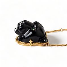 This glossy black Obsidian was hand-carved into a powerful, black panther and brought to life with sparkling Emerald eyes. This wild cat embodies grace and courage. We encased it in an 18k gold bezel with braided detail and prongs. Obsidian is considered to be a highly protective stone so wear it as a protection amulet. One of a kind. Technical Details Metal: 18k yellow goldRainbow Obsidian: 40.52 cts. Emerald EyesChain: can be worn at 16" and 18"Pendant Size: 24 x 22mmClosure: lobster claspHand Luxury Black Spinel Jewelry Gift, Luxury Black Spinel Jewelry As Gift, Luxury Carved Necklaces, Luxury Black Spinel Jewelry, Luxury Black Spinel Jewelry With Polished Finish, Luxury Handmade Onyx Jewelry, Handmade Luxury Black Jewelry, Luxury Handmade Black Jewelry, Black Panther Necklace