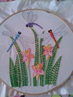 a embroidery project with dragonflies and flowers