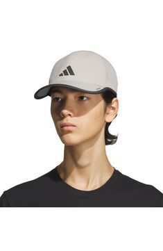 a woman wearing a adidas hat