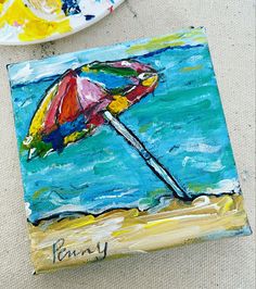 a painting on canvas with an umbrella in the sand