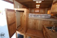 the inside of an rv with wood paneling