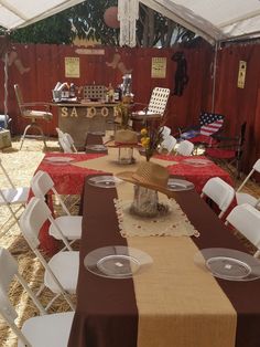 a table set up for an outdoor party with white chairs and brown table cloths