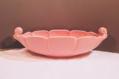 a pink bowl sitting on top of a table