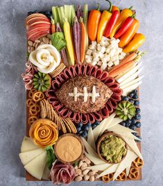 a football themed platter with cheese, crackers, fruit and veggies