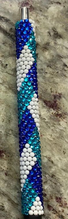 a blue and white beaded lighter holder