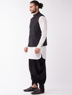 VASTRAMAY Men Cream & Black Layered Kurta with Cowl Dhoti & Jacket This stylish outfit from VASTRAMAY combines cream and black colors in a layered kurta with a cowl dhoti and jacket for a trendy look. Key Features: Layered kurta design Cowl dhoti for added style Included jacket for a complete look Combination of cream and black colors Specifications: Brand: VASTRAMAY Color: Cream & Black Material: Cotton Sizes Available: S, M, L, XL, XXL Material & Care: This outfit is made from high-quality cotton fabric. To maintain its quality, hand wash or machine wash with similar colors. Legal Disclaimer: The product is guaranteed to be 100% genuine. Product images are for illustrative purposes only. Images/packaging/ labels may vary from time to time due to changes made by the manufacturer's manufac Traditional Black Cotton Nehru Jacket, Traditional Black Nehru Jacket For Winter, Traditional Black Outerwear For Eid, Fitted Black Nehru Jacket For Transitional Season, Layered Kurta, Men Cream, Dhoti Pants, Kurta Design, Black Layers