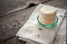 two marshmallows in a glass bowl on a napkin